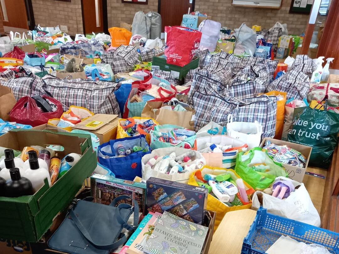 A large number of bags and boxes filled with clothes and toiletries.